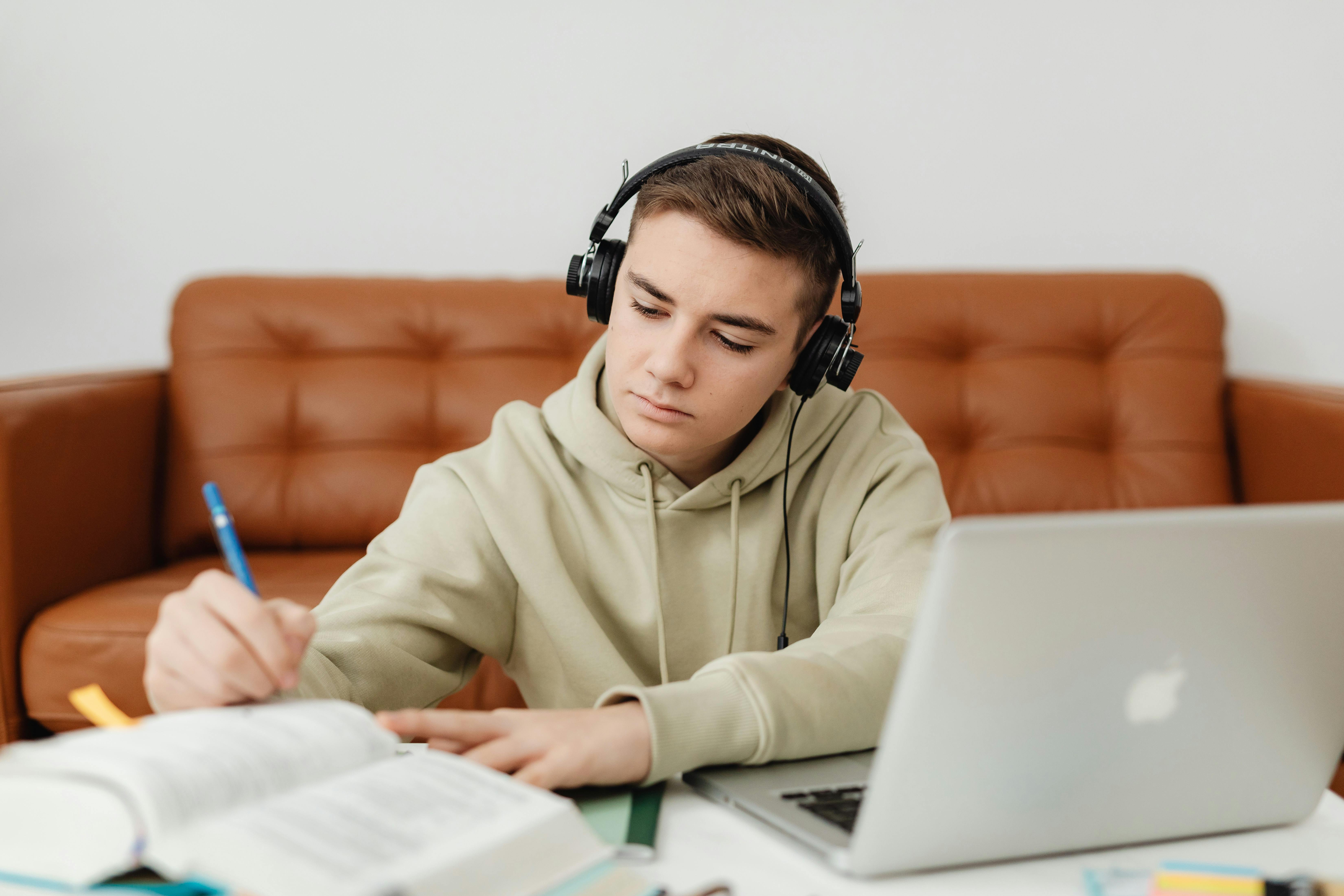 A teenage boy studying at his desk